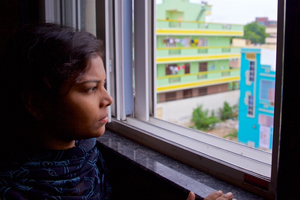 Priyanka looking out at buildings